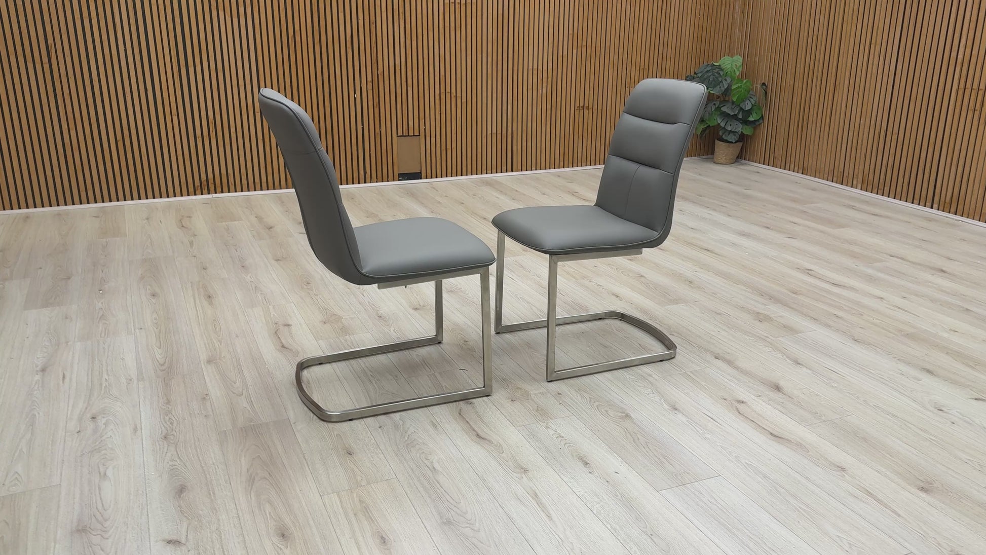 360-degree video showcase of the charcoal cantilever chairs, highlighting the sleek metal frame and cushioned seat.