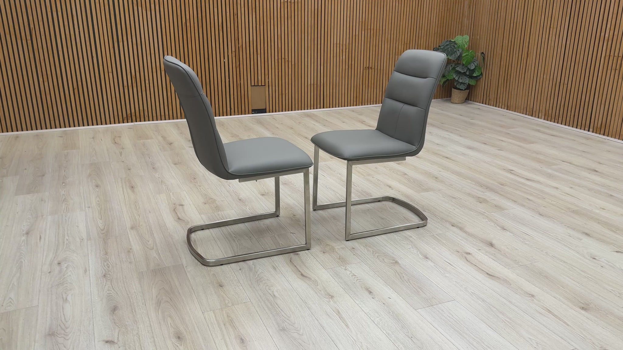 360-degree video showcase of the charcoal cantilever chairs, highlighting the sleek metal frame and cushioned seat.