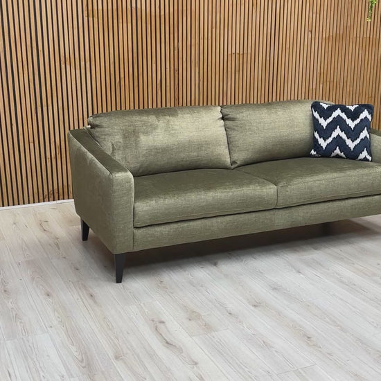 Product video tour of the ‘Oslo’ Vogue Olive Green Velvet 3 Seater Sofa, demonstrating the fabric’s soft-touch texture, the supportive backrest, and the spacious seating capacity.