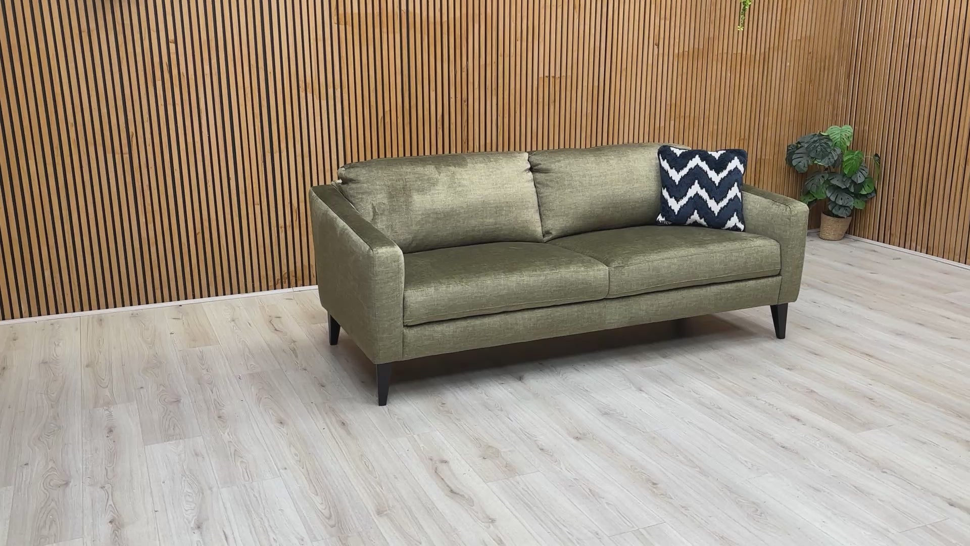 Product video tour of the ‘Oslo’ Vogue Olive Green Velvet 3 Seater Sofa, demonstrating the fabric’s soft-touch texture, the supportive backrest, and the spacious seating capacity.
