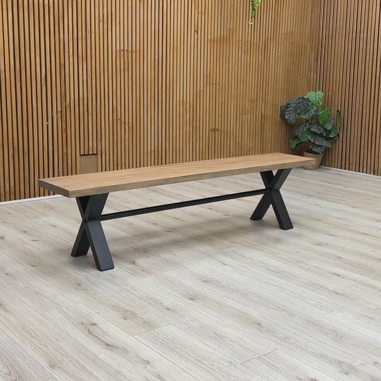 Product walkthrough video demonstrating the Saturn 180cm bench, showcasing the tactile texture of the solid wood grain, the sturdy non-wobble frame construction, and its real-world scale.