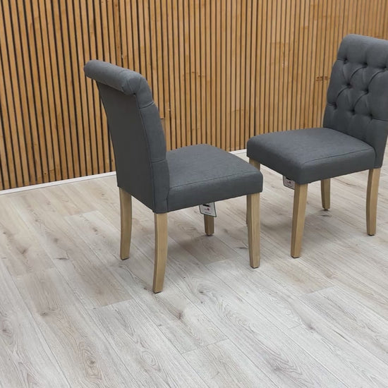 Video showcase of the Lewis dining chairs' fabric texture, buttoned finish, and sturdy rubberwood leg construction.