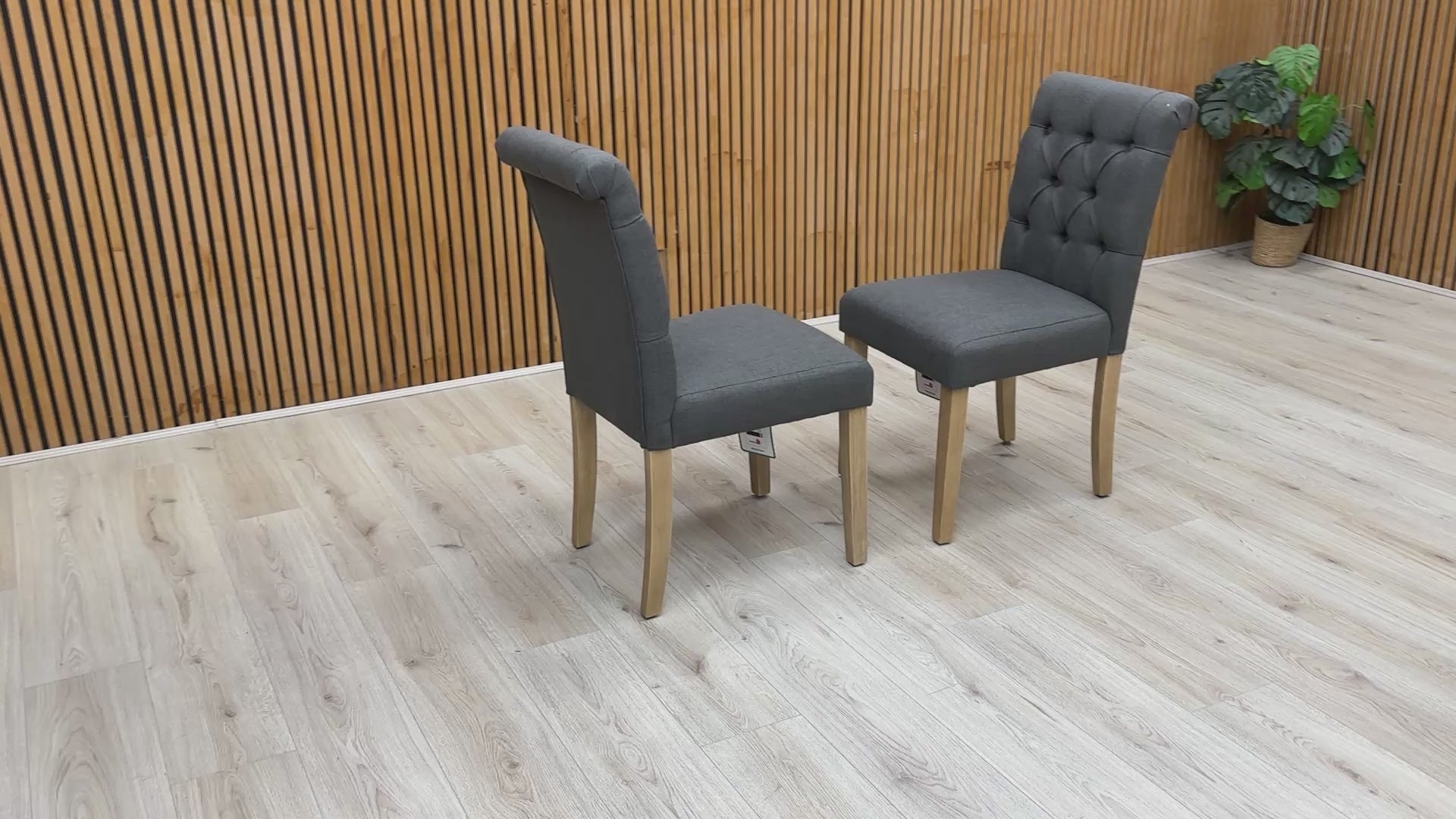 Video showcase of the Lewis dining chairs' fabric texture, buttoned finish, and sturdy rubberwood leg construction.