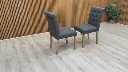 Video showcase of the Lewis dining chairs' fabric texture, buttoned finish, and sturdy rubberwood leg construction.