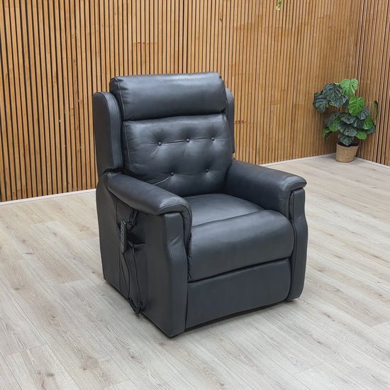A video of a Black leather power recliner with footrest extended with a Wooden Background