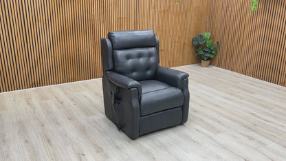 A video of a Black leather power recliner with footrest extended with a Wooden Background