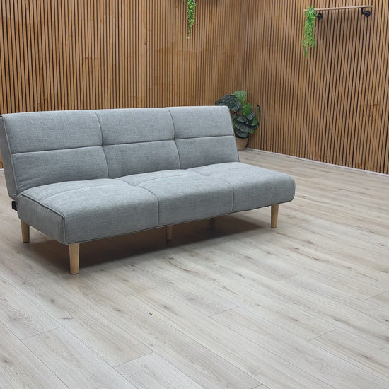Product video tour of the ‘Miyagi’ Mist Grey Fabric Futon Sofa Bed, demonstrating the smooth transition from a stylish upright sofa to a flat, supportive guest bed.