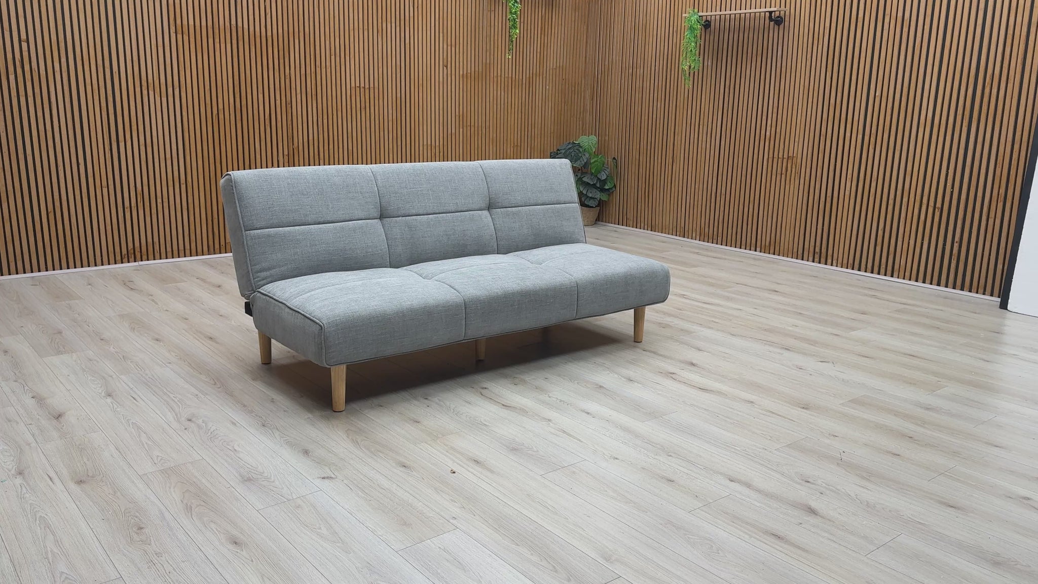 Product video tour of the ‘Miyagi’ Mist Grey Fabric Futon Sofa Bed, demonstrating the smooth transition from a stylish upright sofa to a flat, supportive guest bed.