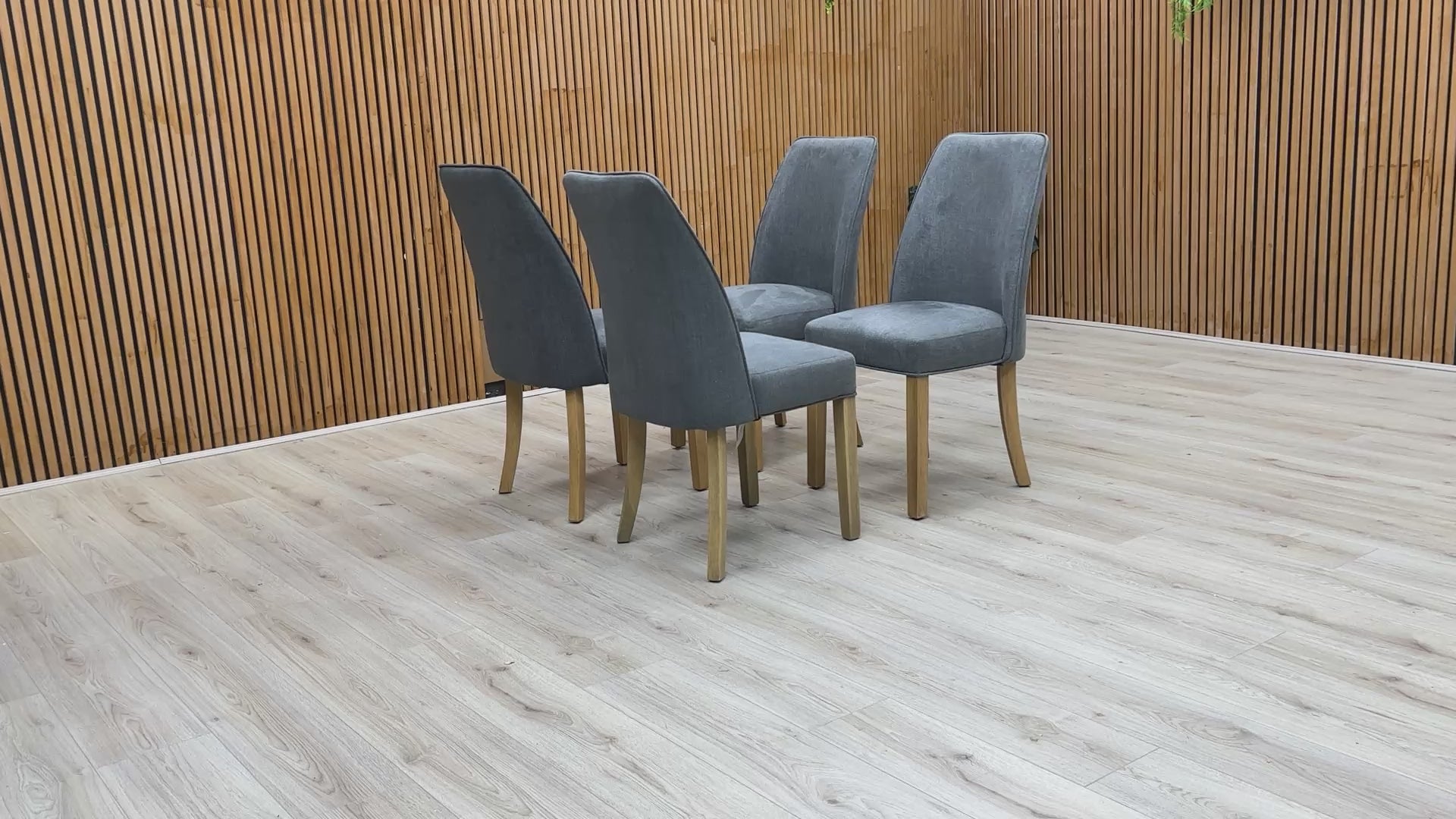 Video showing Set of 4 Hamilton Charcoal Grey Fabric Dining Chairs with contemporary upholstered design and wooden legs.