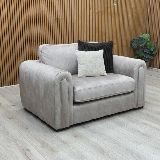 Product walkthrough video demonstrating the snuggle chair's impressive size, cushion resilience, and soft fabric texture, highlighting its cozy seating area.