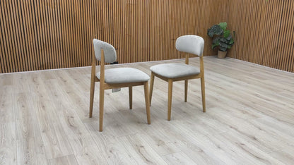 Product video tour of the ‘Stockholm’ Light Oak Wooden Dining Chairs, demonstrating the smooth tactile finish of the wood, structural stability, and weight-bearing strength.