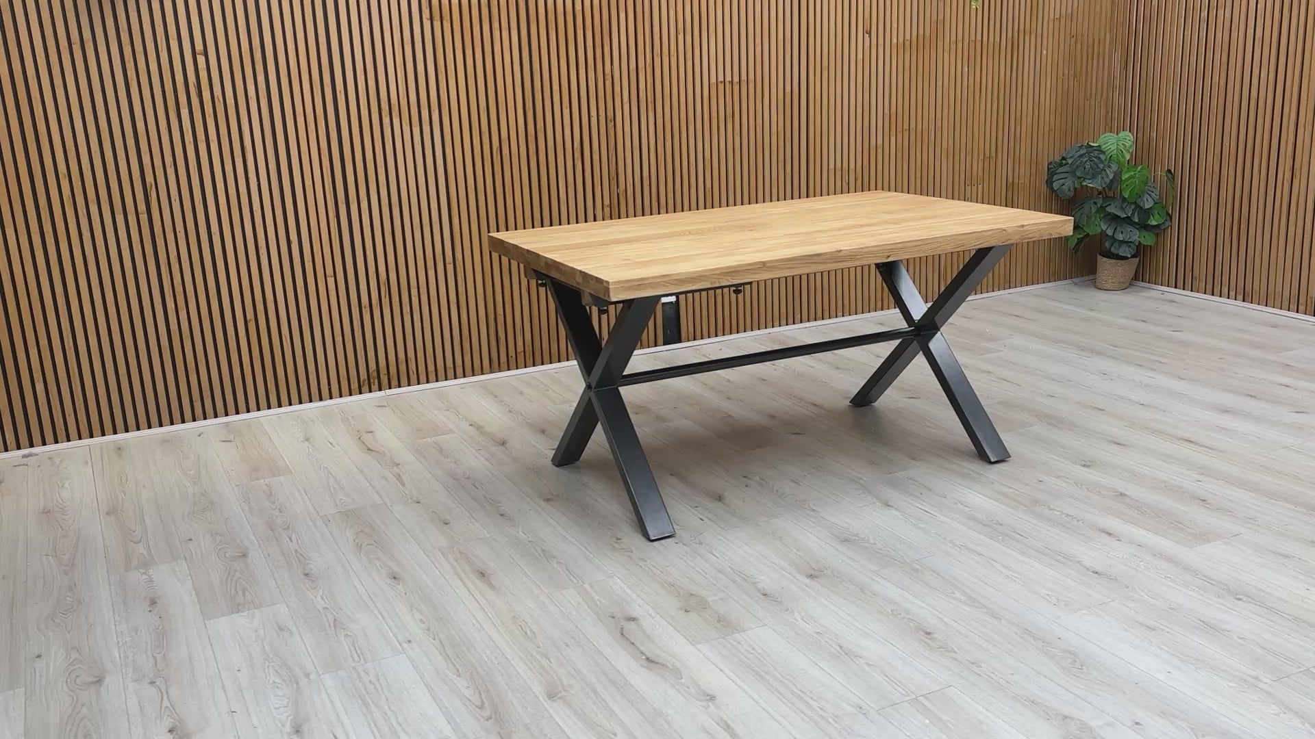 A video of the Earth dining table, panning across the wire-brushed oak surface and metal base.