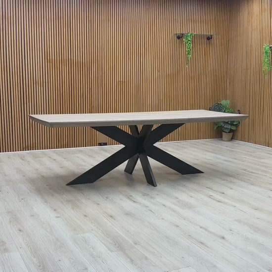 Video Of ‘Bodahl Terra’ industrial 240cm dining table, featuring an organic live-edge solid oak tabletop in a sophisticated Vintage Grey finish, supported by a striking architectural metal star base.