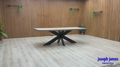 Video Of ‘Bodahl Terra’ industrial 240cm dining table, featuring an organic live-edge solid oak tabletop in a sophisticated Vintage Grey finish, supported by a striking architectural metal star base.