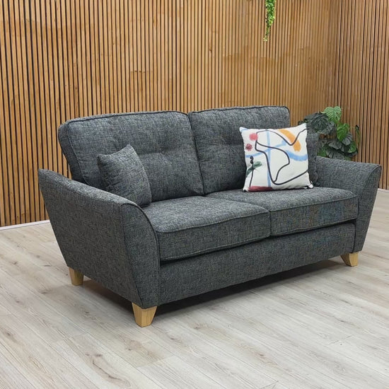Product video tour of the ‘Halstow’ Charcoal Fabric 2-Seater Sofa, demonstrating cushion bounce-back resilience, fabric durability, and overall frame stability.