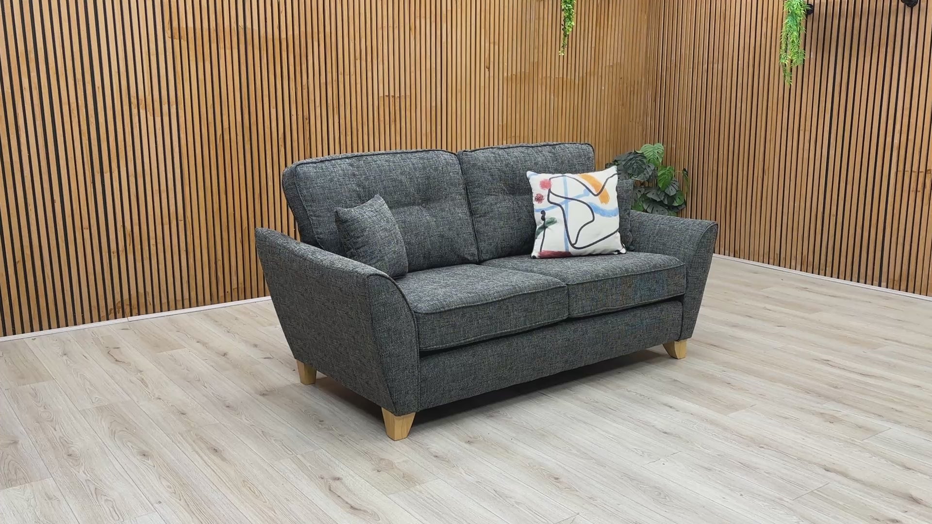 Product video tour of the ‘Halstow’ Charcoal Fabric 2-Seater Sofa, demonstrating cushion bounce-back resilience, fabric durability, and overall frame stability.