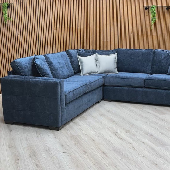 Video tour showing the 'Chelsea' navy sofa, demonstrating the soft feel of the fabric and the bounce-back of the foam cushions.
