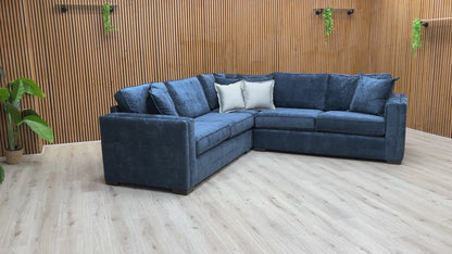 Video tour showing the 'Chelsea' navy sofa, demonstrating the soft feel of the fabric and the bounce-back of the foam cushions.