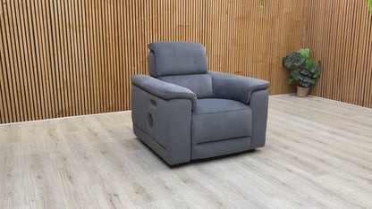 Product video tour of the ‘Genius’ Bella Iron Grey Power Recliner, demonstrating the smooth reclining action, adjustable power headrest, and Bluetooth audio connectivity.