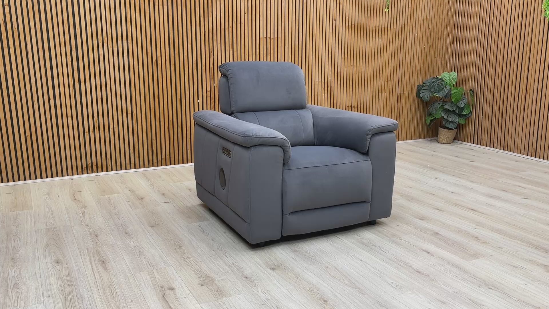 Product video tour of the ‘Genius’ Bella Iron Grey Power Recliner, demonstrating the smooth reclining action, adjustable power headrest, and Bluetooth audio connectivity.