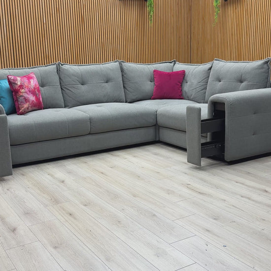 Video demonstrating the unique pull-out storage drawers hidden within the wide armrests of the Goliath sofa.