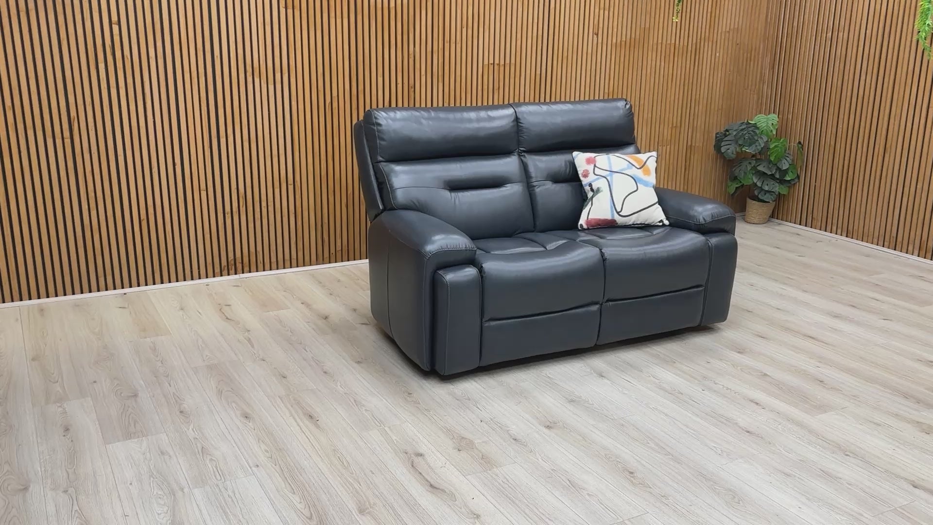 Product video tour of the ‘Cinemax’ Natural Milled Navy Leather 2 Seater Sofa, demonstrating the leather's natural grain, seat firmness, and overall build quality.