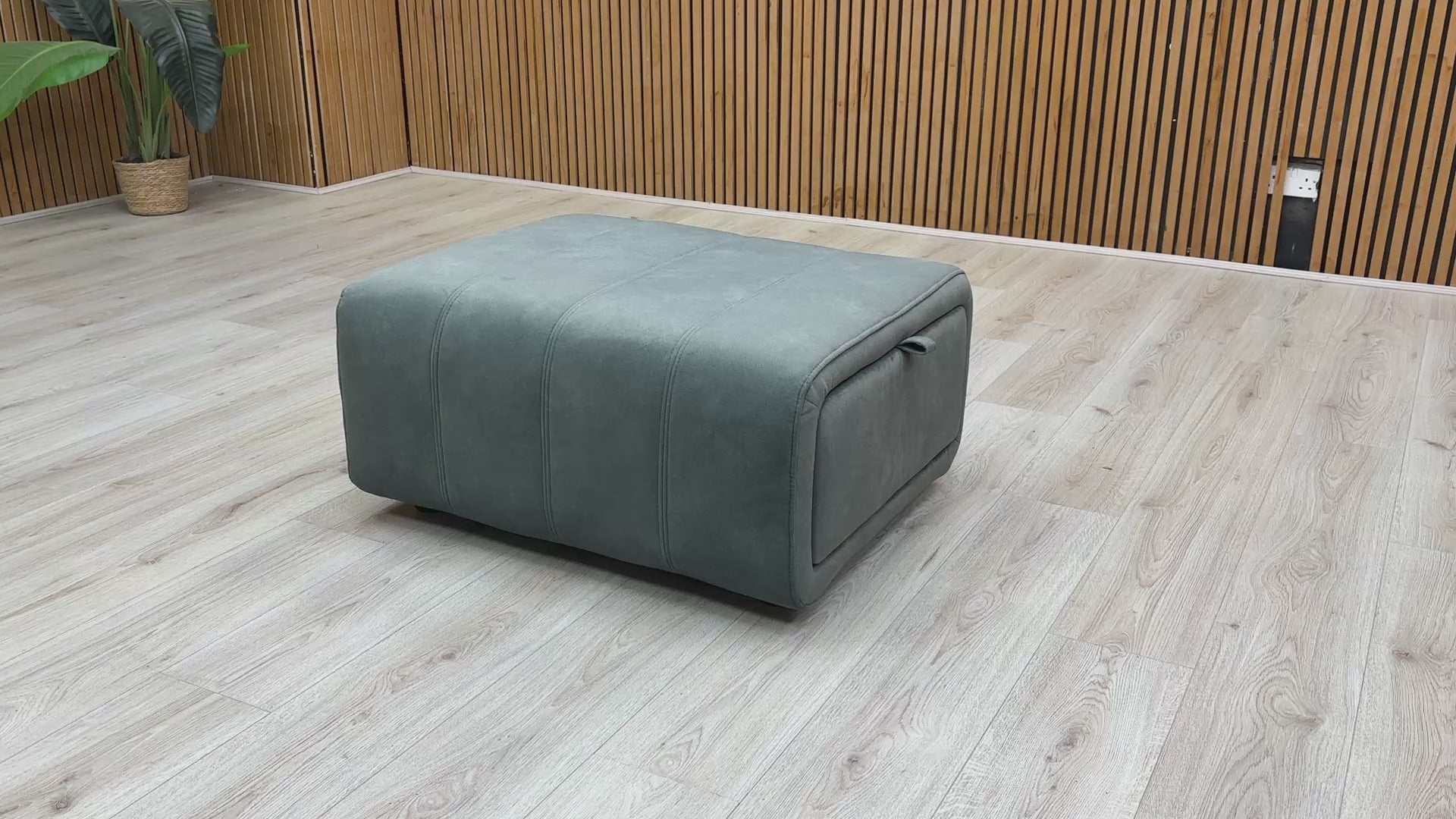 Video for a product video demonstrating the storage function and velvet upholstery of the 'Elphaba' Fern Green footstool.
