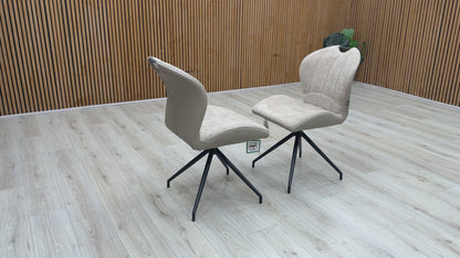Video walkthrough showcasing the Raul pebble taupe fabric dining chairs, demonstrating the smooth auto-return swivel function, fabric texture under showroom lighting, and overall stability.