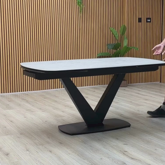 Video Of ‘Julio’ ultra-modern 160cm draw-leaf extending dining table, featuring a sleek silver grey ceramic top surface paired with a dramatic contemporary black metal base.