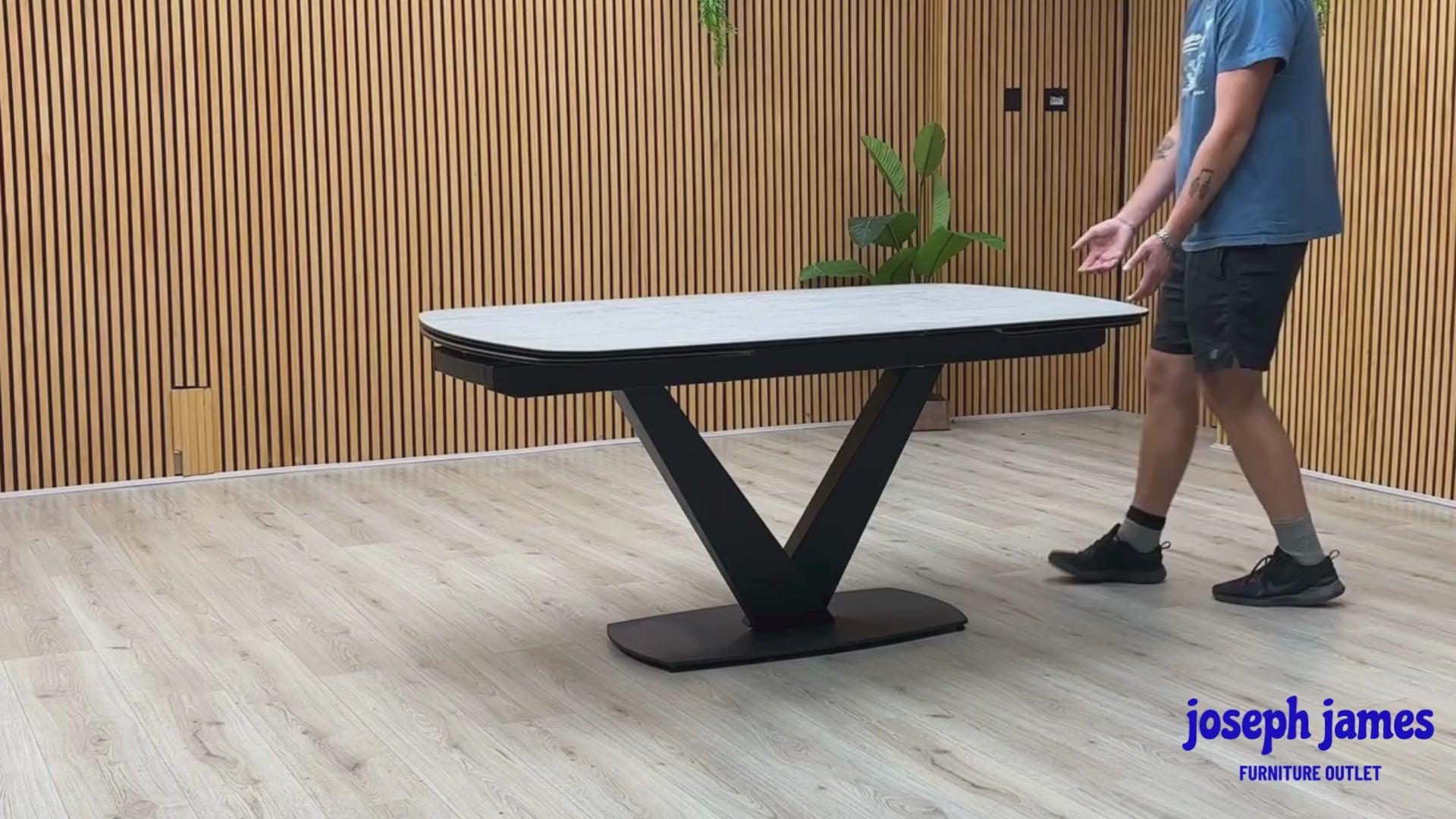 Video Of ‘Julio’ ultra-modern 160cm draw-leaf extending dining table, featuring a sleek silver grey ceramic top surface paired with a dramatic contemporary black metal base.
