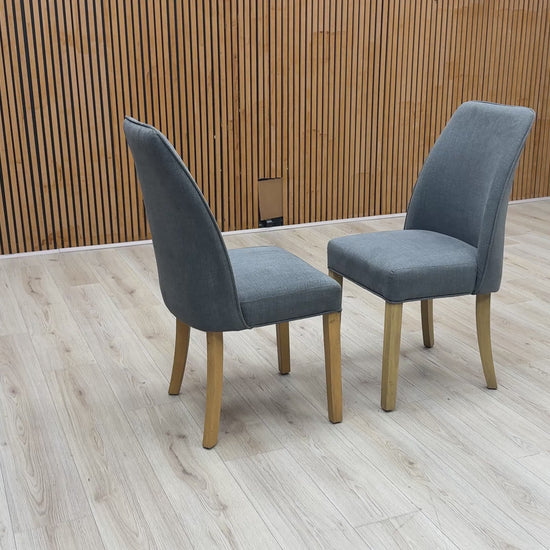 Product walk-around video of the Furnitureland Hamilton Charcoal Grey Fabric Dining Chairs, showcasing the fabric texture quality, frame stability, and comfortable depth.