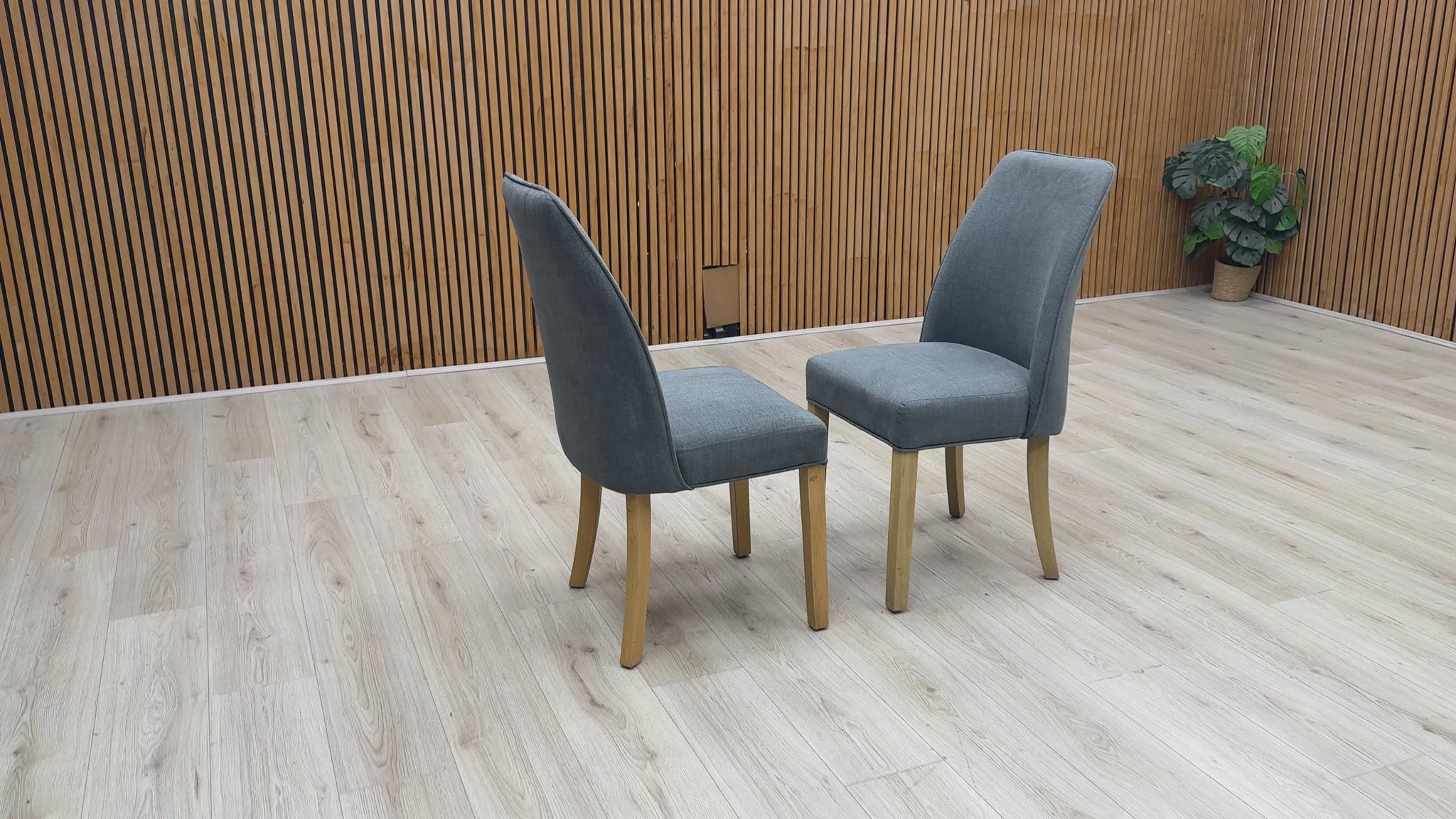 Product walk-around video of the Furnitureland Hamilton Charcoal Grey Fabric Dining Chairs, showcasing the fabric texture quality, frame stability, and comfortable depth.