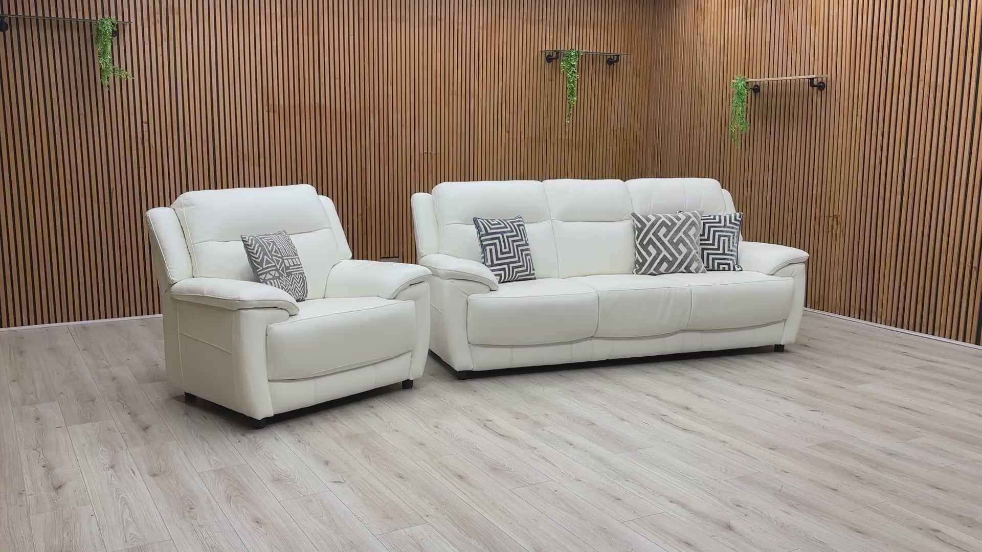 Video walkthrough showcasing the World of Leather Touch Star White leather 3-seater sofa and armchair, demonstrating leather resilience, cushion bounce-back, and frame stability.