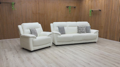 Video walkthrough showcasing the World of Leather Touch Star White leather 3-seater sofa and armchair, demonstrating leather resilience, cushion bounce-back, and frame stability.