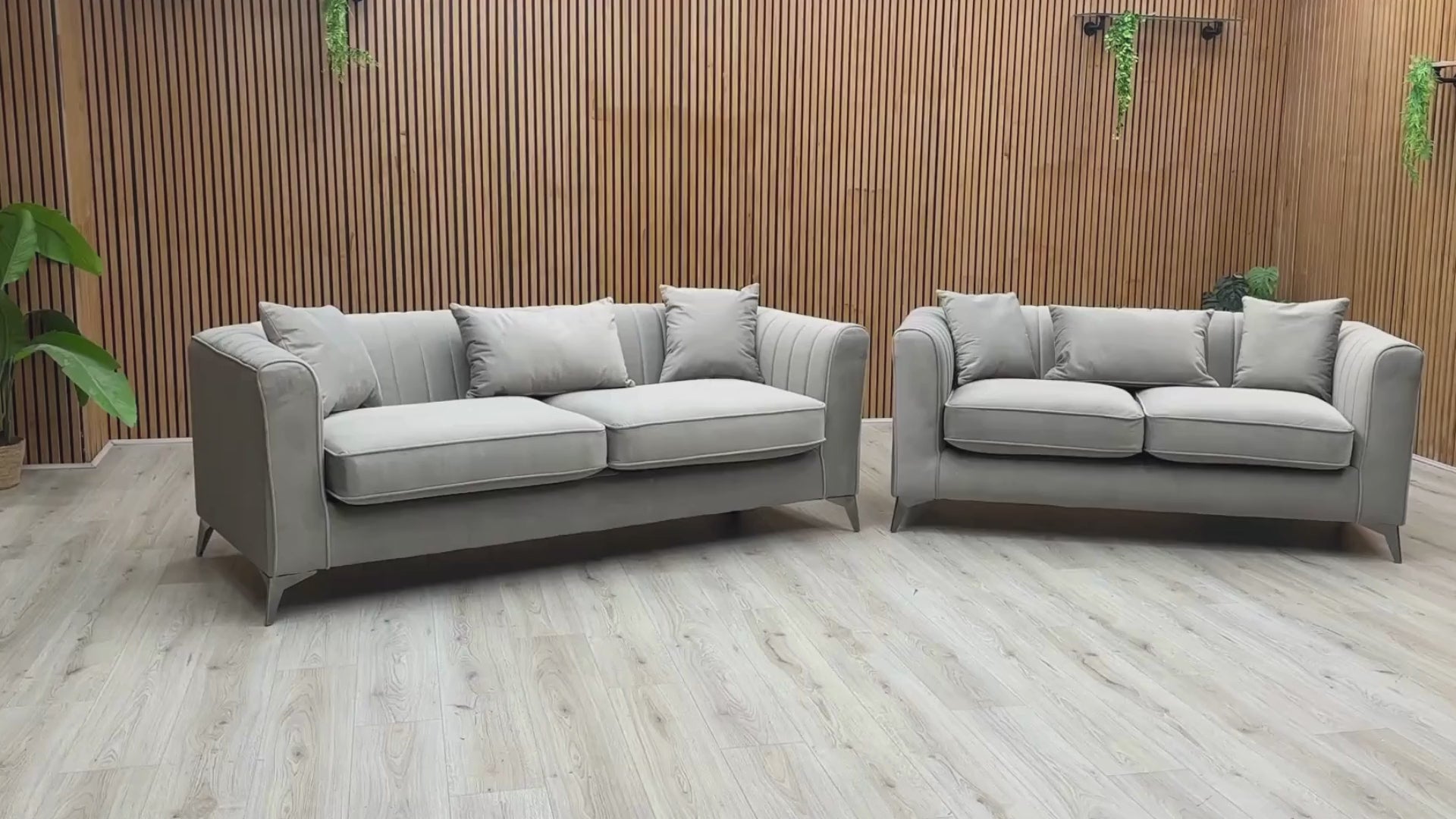 Video Of ‘Sirius’ contemporary living room furniture set, featuring a 3-seater sofa and a matching 2-seater sofa, beautifully upholstered in luxurious Pebble Grey velveteen fabric with a classic back design.