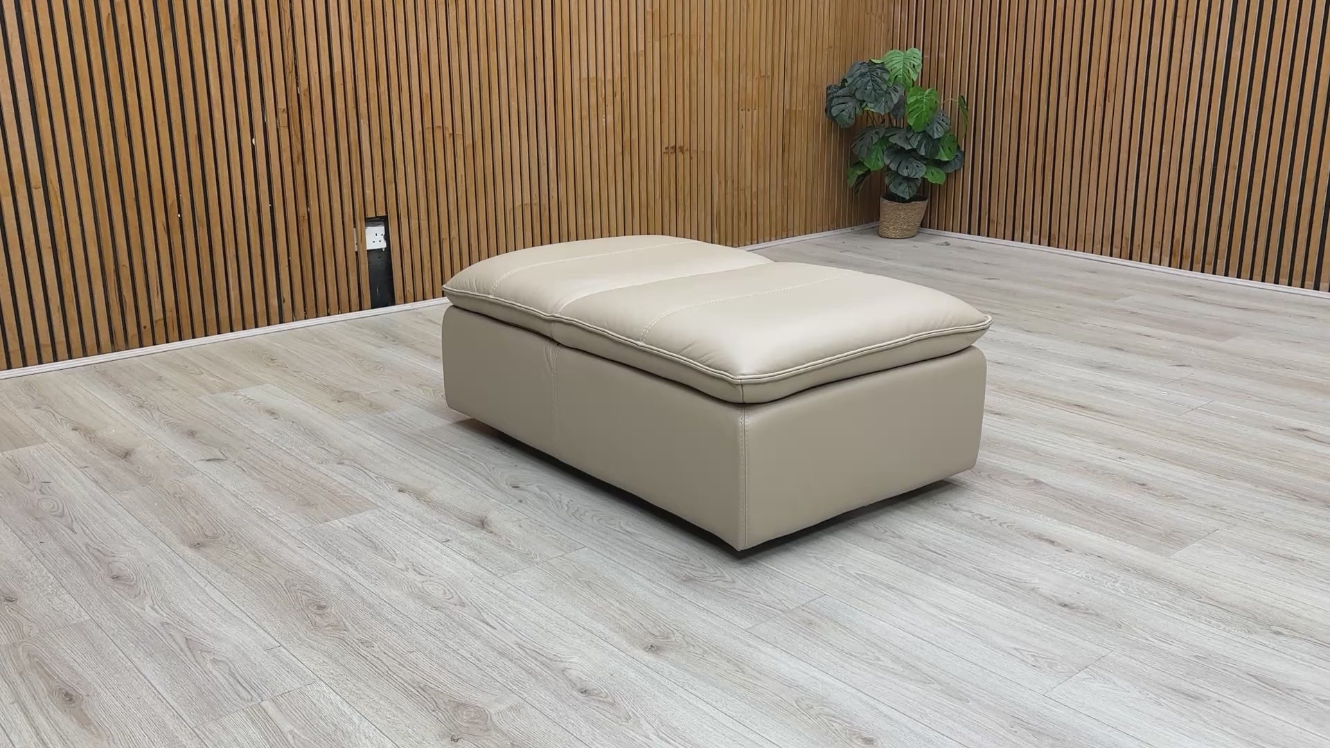 Video Of Leather Storage Footstool with the lid slightly ajar, highlighting the practical storage design.