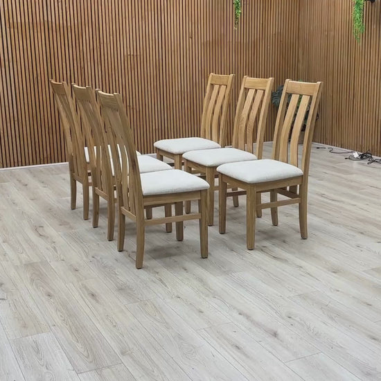 Video Of ‘Furnitureland Augusta’ contemporary dining chairs, showing a matching set of 6 individual chairs featuring an elegant wooden slatted-back design and padded seats upholstered in Clay fabric.
