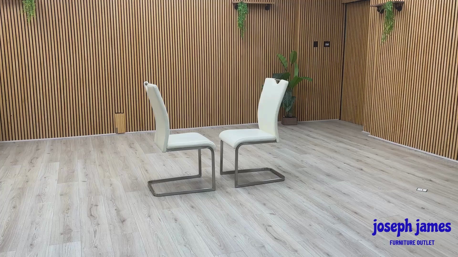 Video Of ‘Bianco’ contemporary dining chair set, showcasing a pair of sleek chairs beautifully upholstered in crisp White faux leather supported by minimalist chrome cantilever bases.