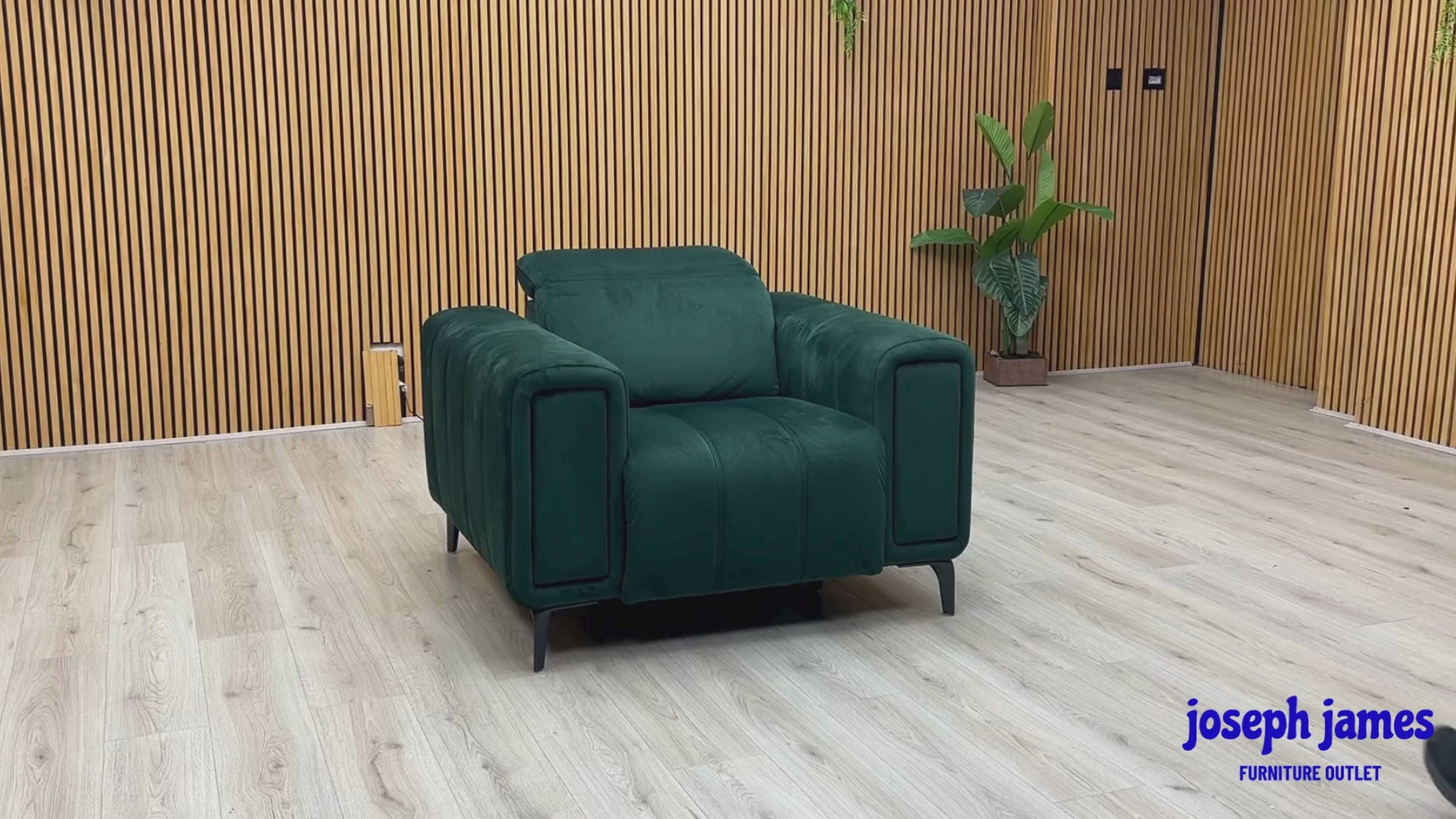 Video Of ‘Elphaba’ contemporary power recliner armchair, beautifully upholstered in an elegant, rich Opulence Bottle Green fabric, featuring integrated storage armrests.