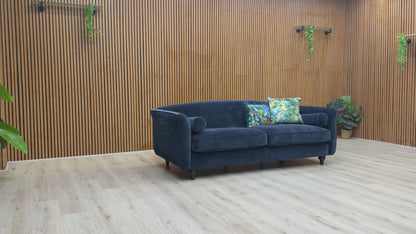Video showcase of the Dame navy blue 4-seater sofa, demonstrating fabric quality and seat firmness.