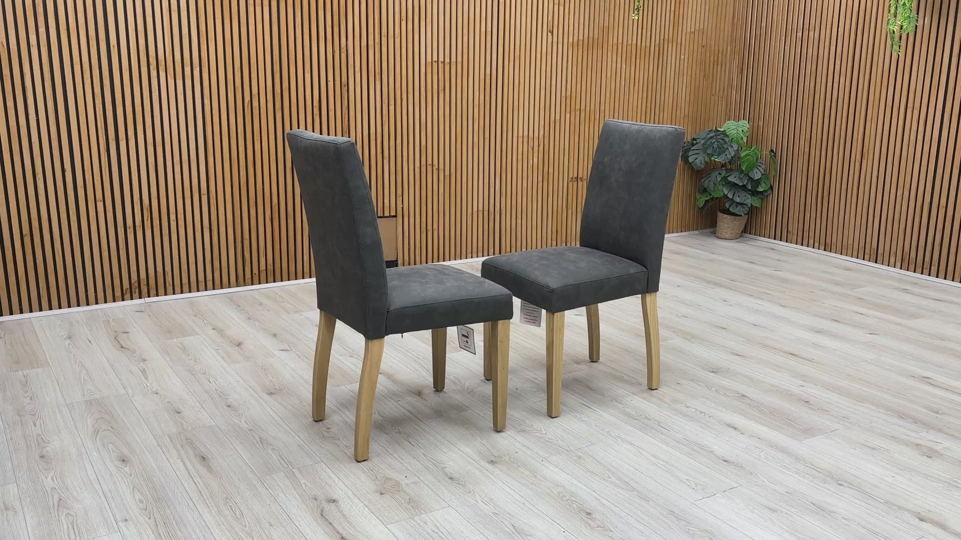 Product video tour of the Furnitureland ‘Augusta’ Grey Cowboy Upholstered Dining Chairs, demonstrating the fabric’s unique texture, the resilience of the seat padding, and overall structural stability.