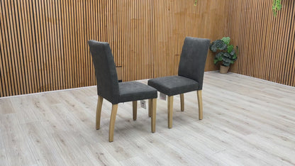 Product video tour of the Furnitureland ‘Augusta’ Grey Cowboy Upholstered Dining Chairs, demonstrating the fabric’s unique texture, the resilience of the seat padding, and overall structural stability.