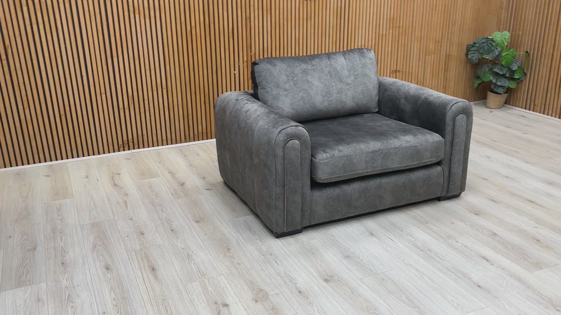 Video tour of the ‘Amara’ charcoal velvet snuggle chair, demonstrating the fabric’s sheen and seat comfort.