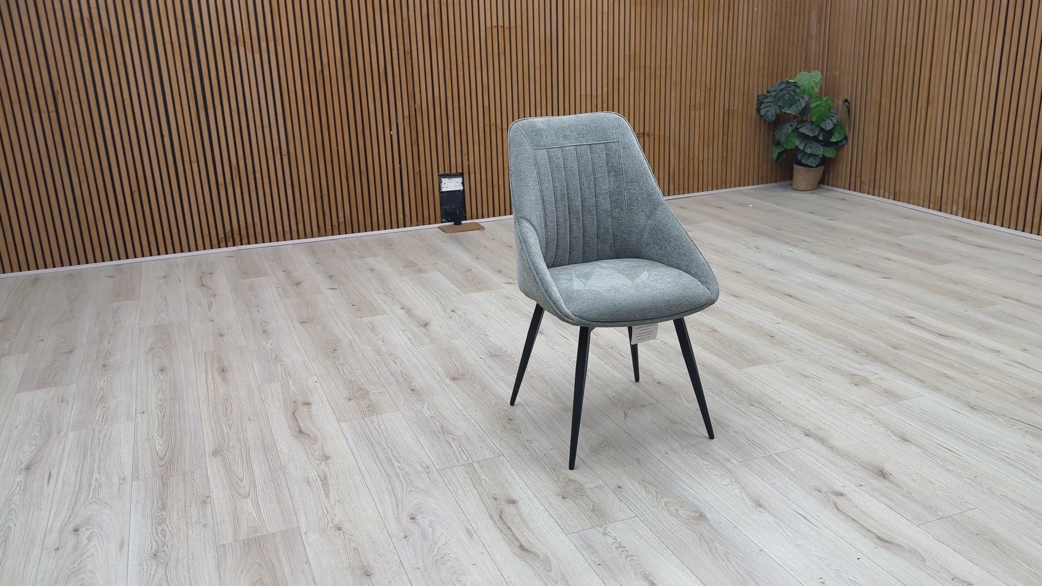 Video Of ‘Crete’ contemporary swivel dining chair, beautifully upholstered in a sophisticated, textured Light Grey fabric with clean, modern lines.
