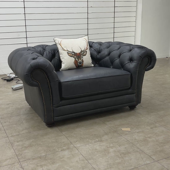 Video showcasing the 'Savannah' navy blue leather snuggler chair from multiple angles, highlighting the quality of the leather and construction.