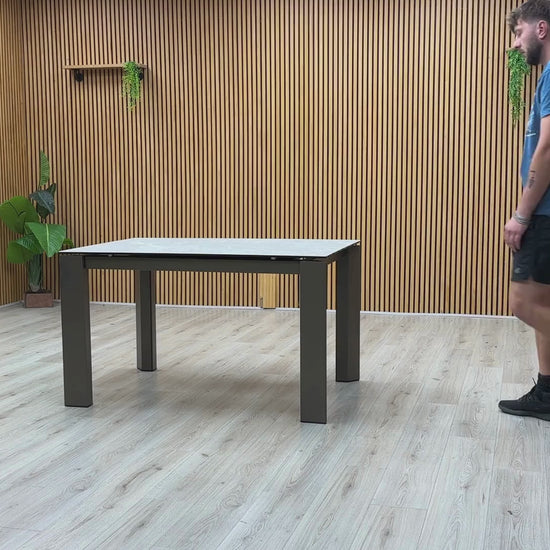 Video Of Connubia ‘Viola’ contemporary extending dining table, showcasing a high-performance matte charcoal grey ceramic top paired with sleek, minimalist black metal legs.