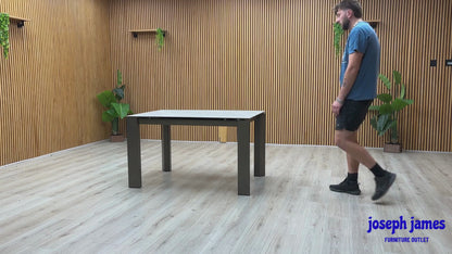 Video Of Connubia ‘Viola’ contemporary extending dining table, showcasing a high-performance matte charcoal grey ceramic top paired with sleek, minimalist black metal legs.