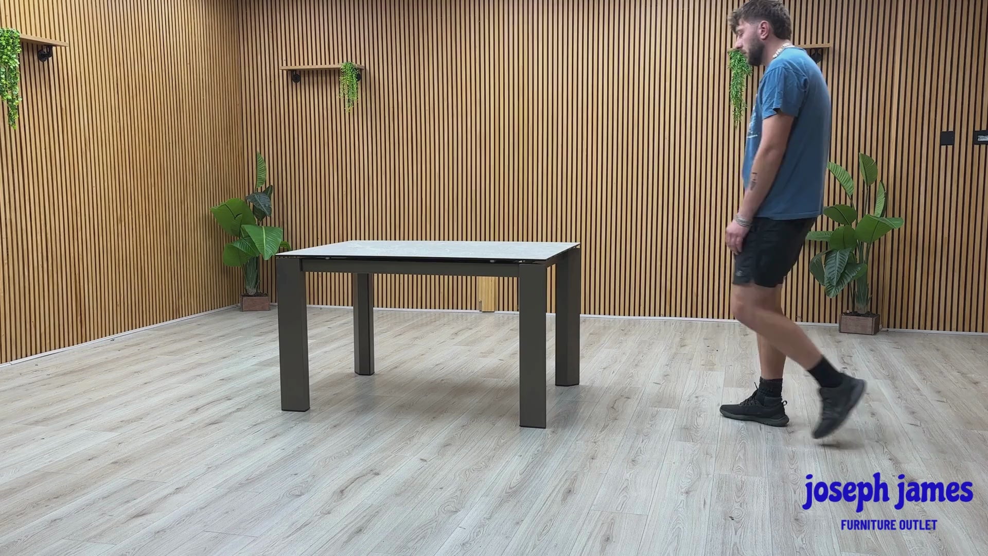 Video Of Connubia ‘Viola’ contemporary extending dining table, showcasing a high-performance matte charcoal grey ceramic top paired with sleek, minimalist black metal legs.