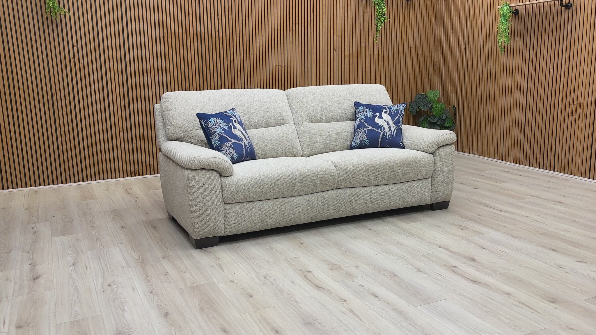 A video of Beige sofa with decorative pillows on a wooden floor and wall background