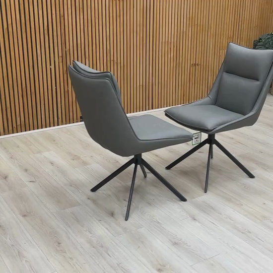 Video Of ‘Catalina’ contemporary dining suite, featuring a matching set of 2 swivel dining chairs beautifully upholstered in a sophisticated Dark Grey faux leather.